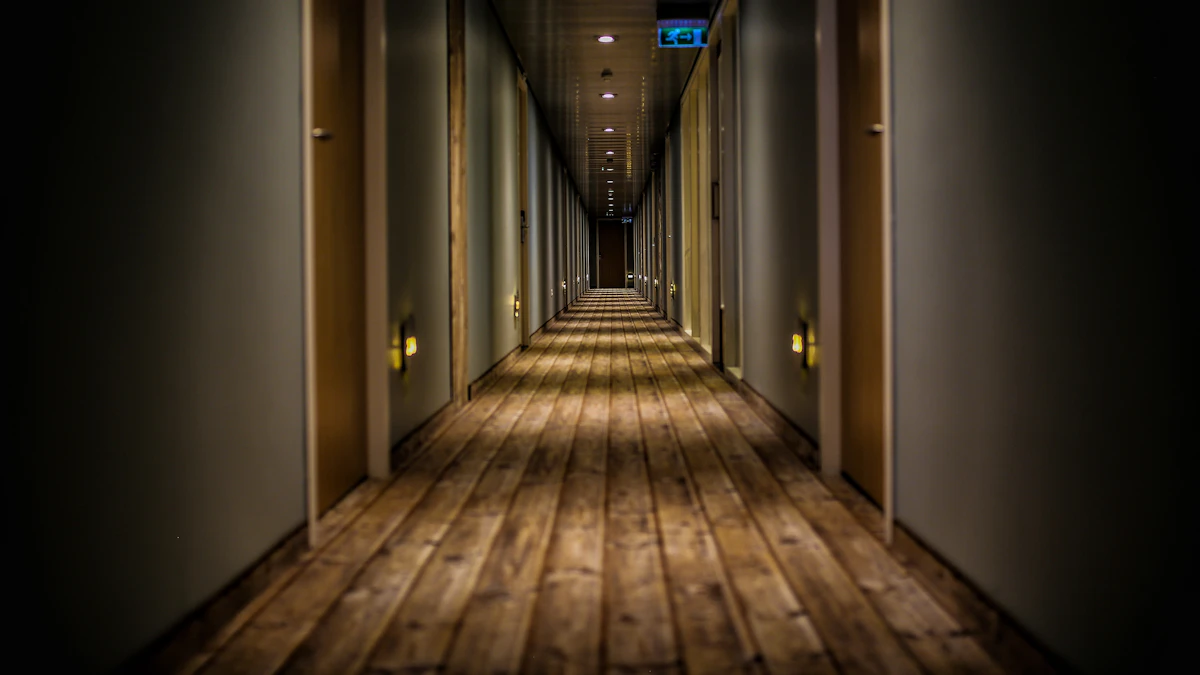 A quiet apartment hallway with several doors.