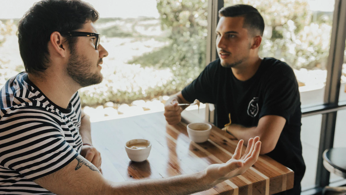 Two adult men having a serious conversation at a table.