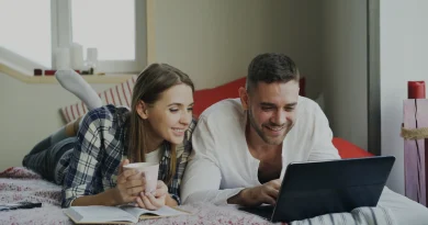 A married couple discussing finances together at home with a laptop.