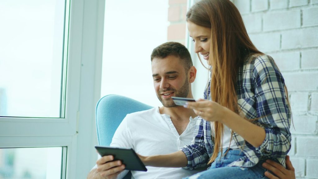 A couple reviewing information together, representing a conversation about shared finances.