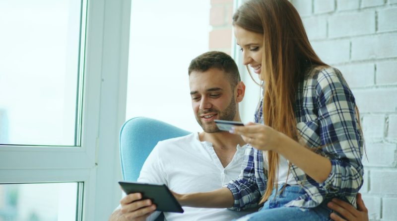 A couple reviewing information together, representing a conversation about shared finances.
