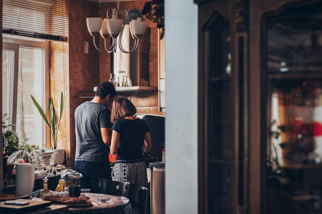 A couple together in a home kitchen.