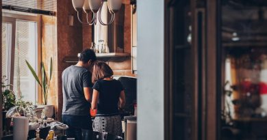 A couple together in a home kitchen.