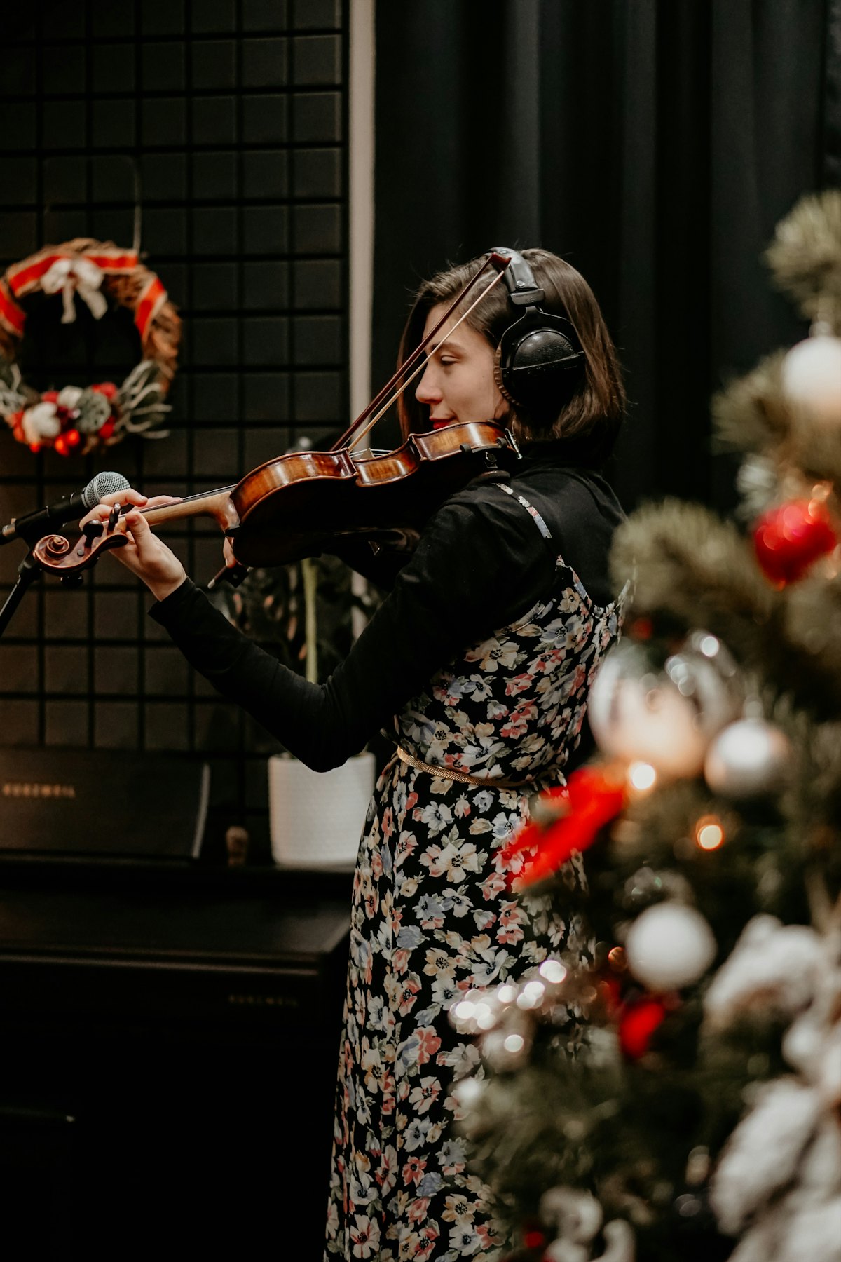 A young violinist practicing indoors with her instrument.
