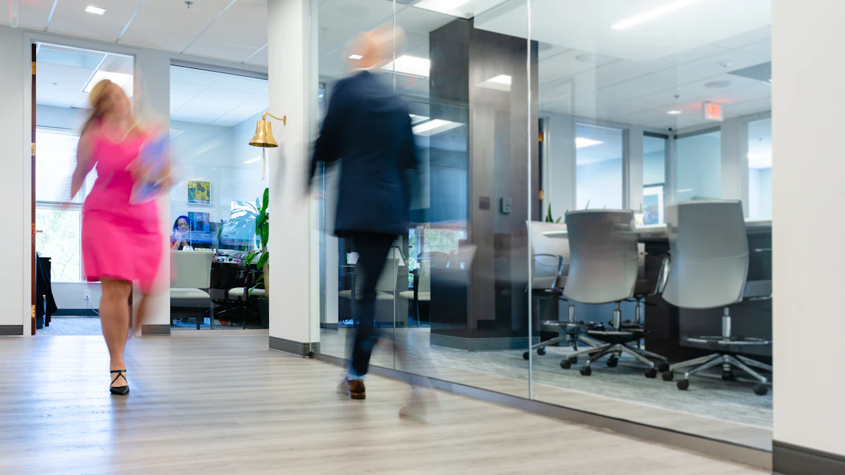 An employee walking through an office corridor in the afternoon.