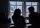 Two people sitting together in the evening, representing a private conversation.