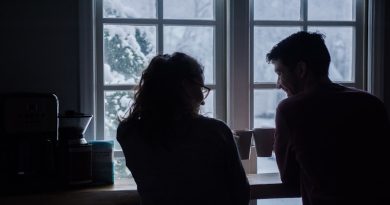 Two people sitting together in the evening, representing a private conversation.