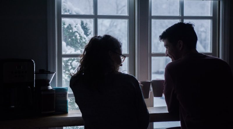 Two people sitting together in the evening, representing a private conversation.