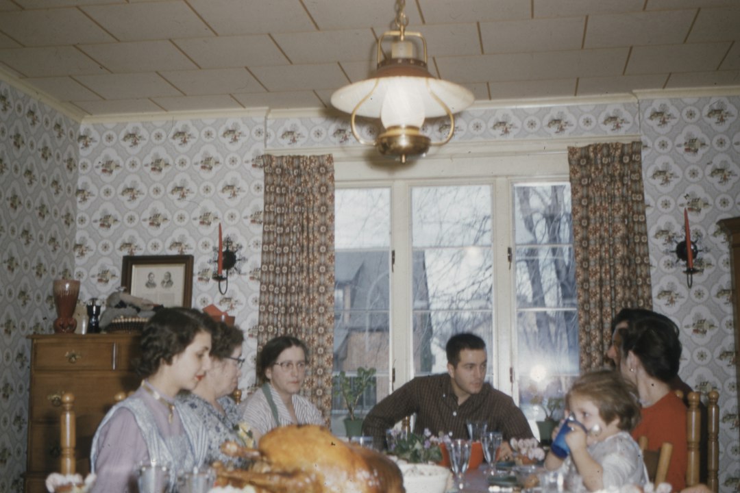 Family members gathered around a dining table