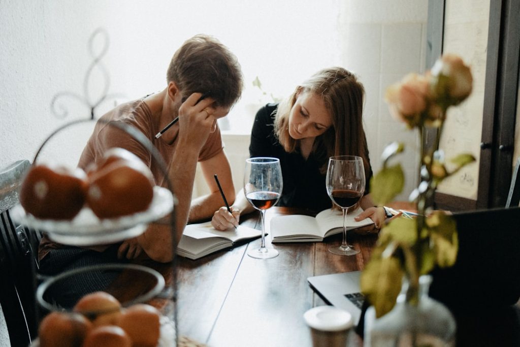 Two adults talking together at a table, representing a family caregiving conversation.