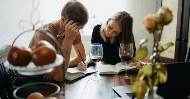 Two adults talking together at a table, representing a family caregiving conversation.