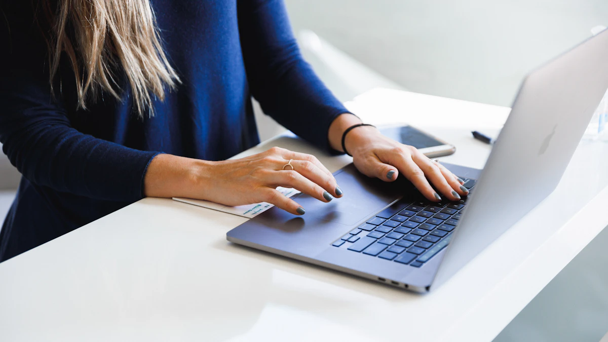 A professional woman working with focused attention on a laptop.
