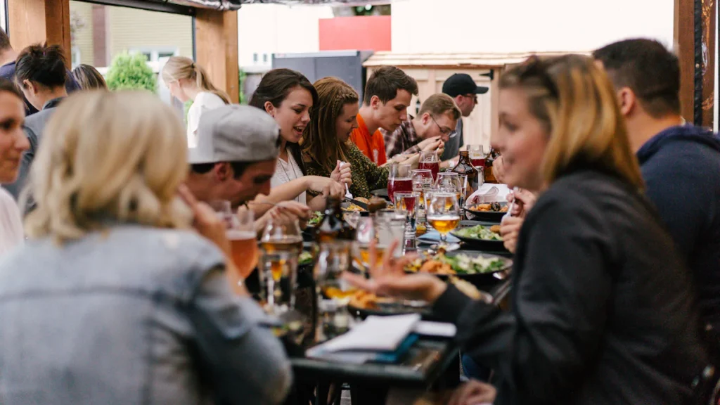 A group of friends sharing dinner around a table.