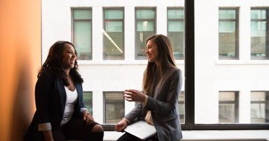 Two female friends in conversation, representing a friendship strained after a promotion.