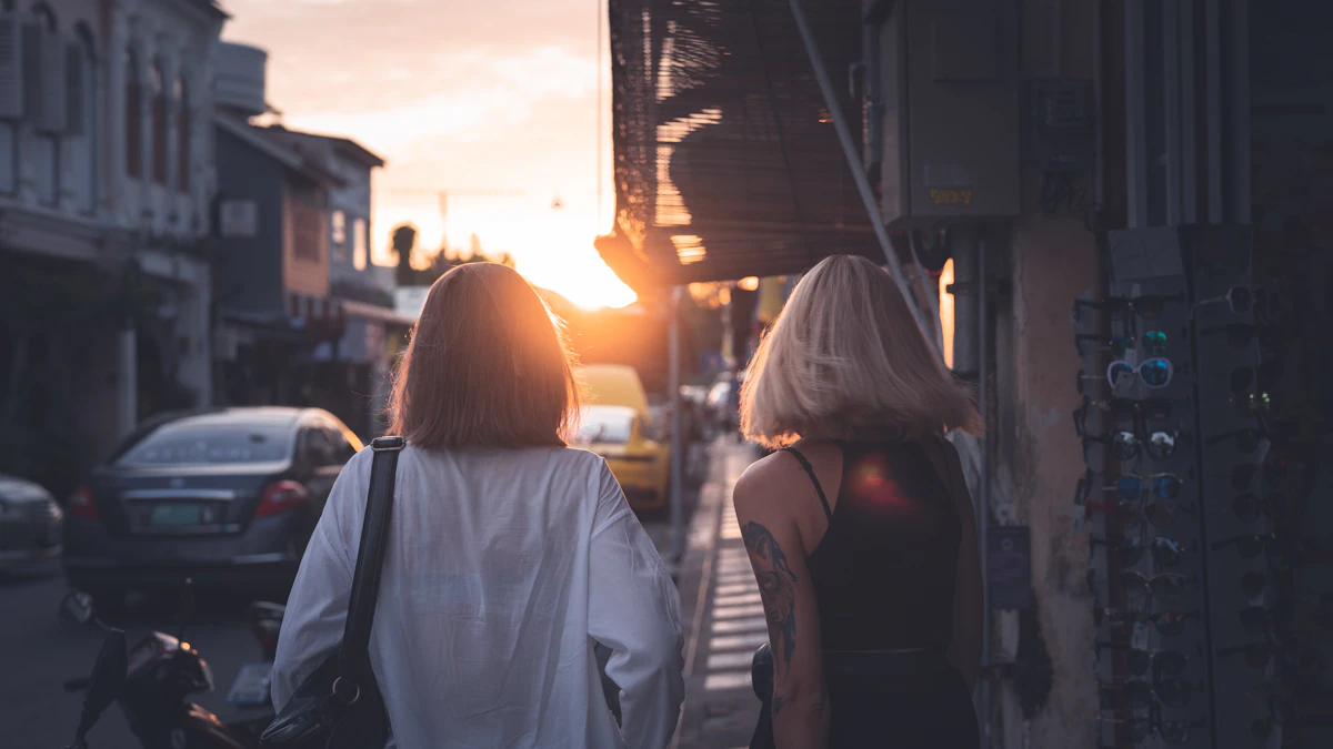 Two friends walking together along a city sidewalk.