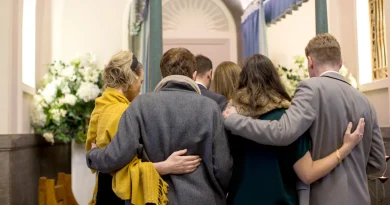 People comforting one another during a funeral gathering.