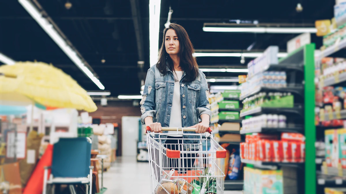 A shopper pushing a grocery cart between supermarket shelves.