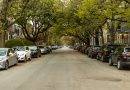 Cars parked along a neighborhood street near residential driveways.