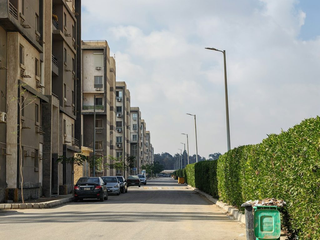 A residential street, representing a dispute between neighbors over trash bins and curb space.