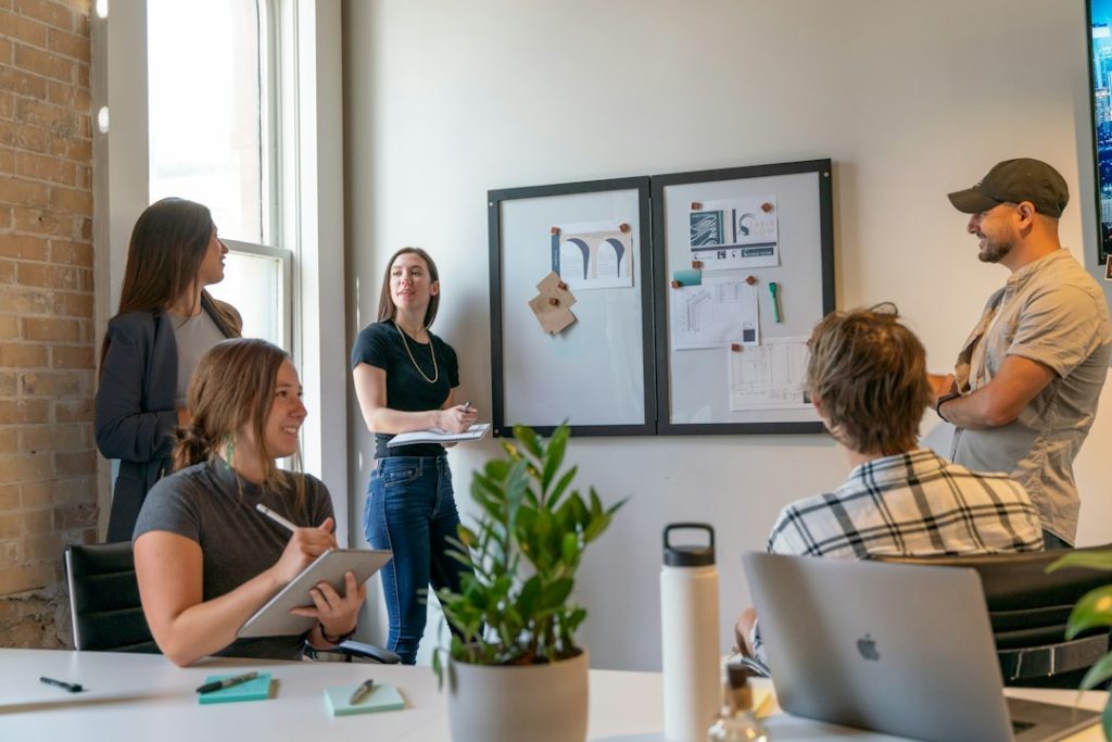 Coworkers collaborating in a modern office meeting.