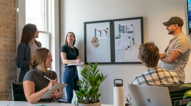 Coworkers collaborating in a modern office meeting.