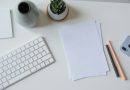 A handwritten note and papers on an office desk.