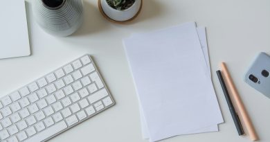 A handwritten note and papers on an office desk.