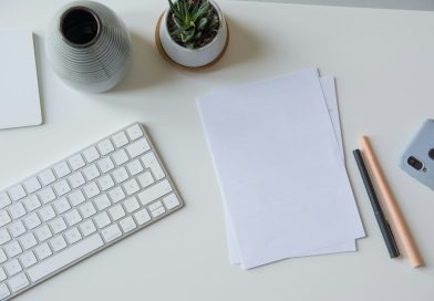 A handwritten note and papers on an office desk.