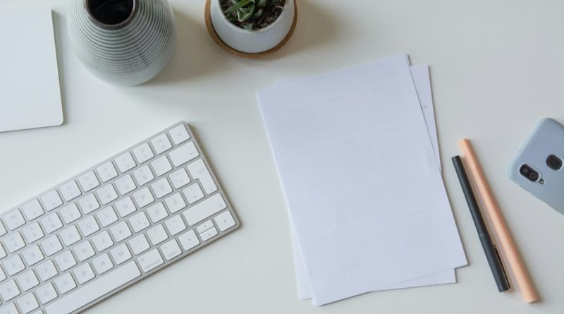 A handwritten note and papers on an office desk.