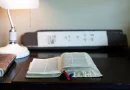 An old open library book resting on a desk.