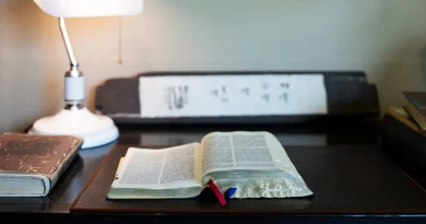 An old open library book resting on a desk.