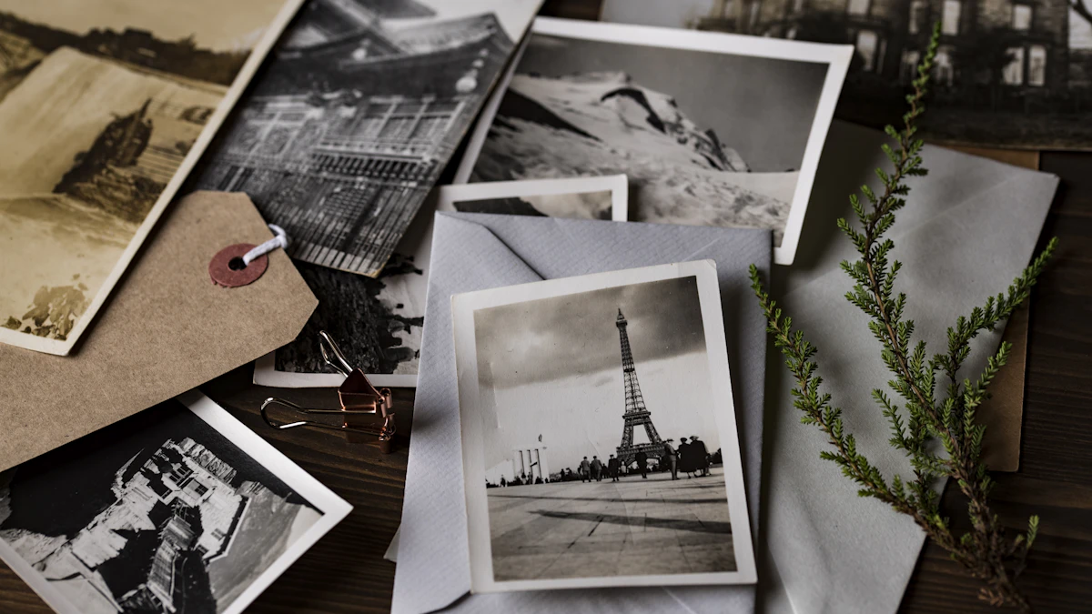 A collection of old printed photographs arranged on a table.