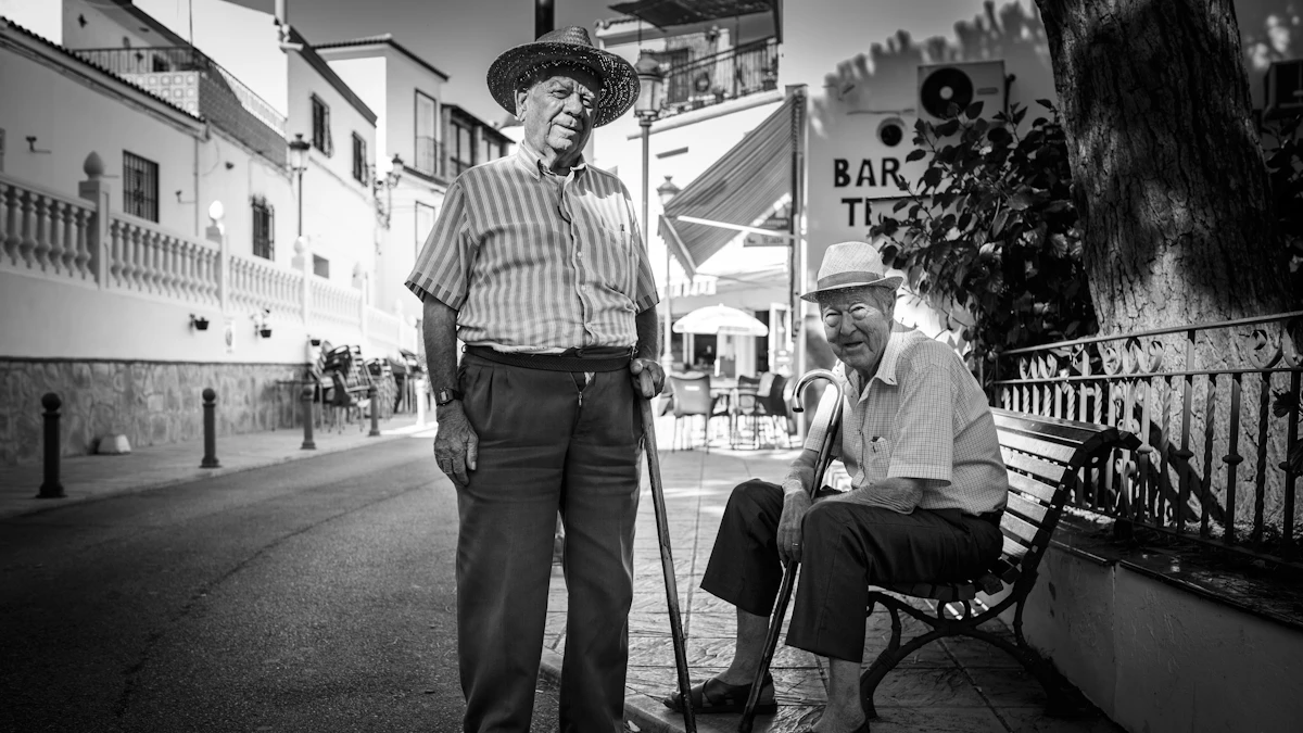 Two older men standing together in a quiet street.