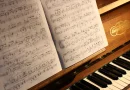 A piano with open sheet music ready for practice.