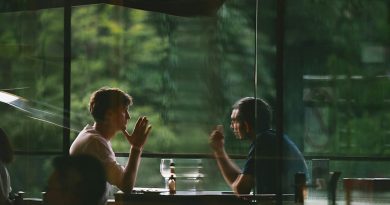 A man and his ex-wife talking over documents at a restaurant table during a weekly lunch.
