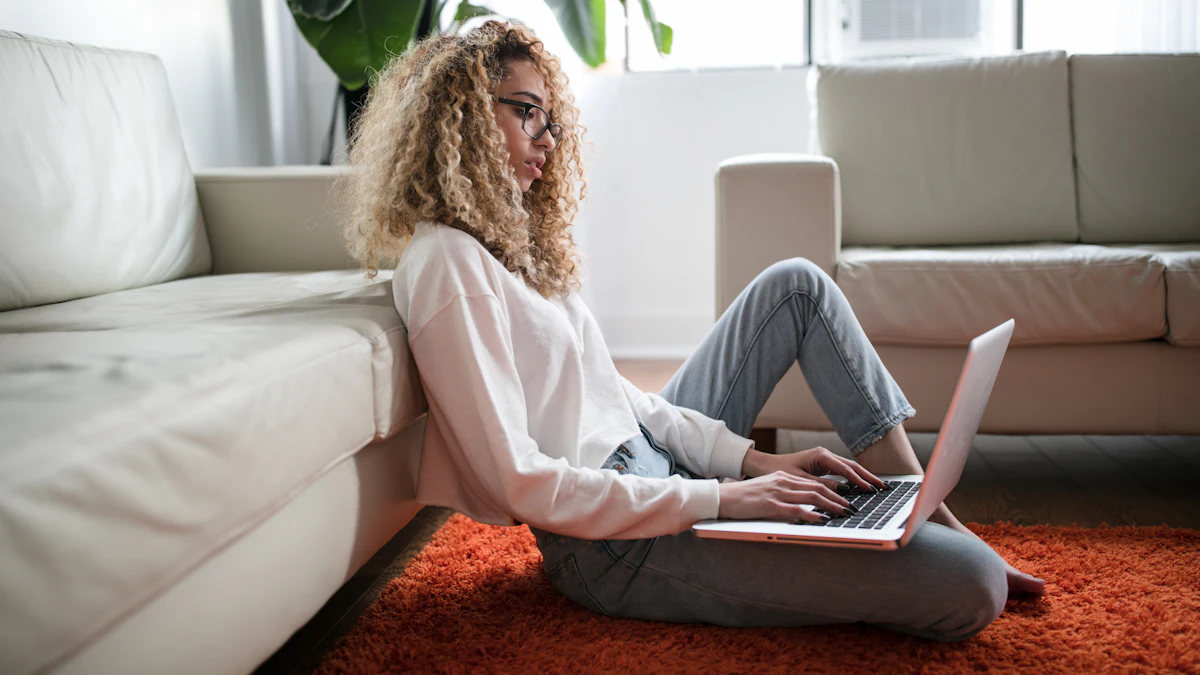 A woman sitting alone at home with a laptop.
