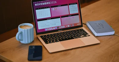 A laptop displaying a work calendar beside a notebook and coffee.