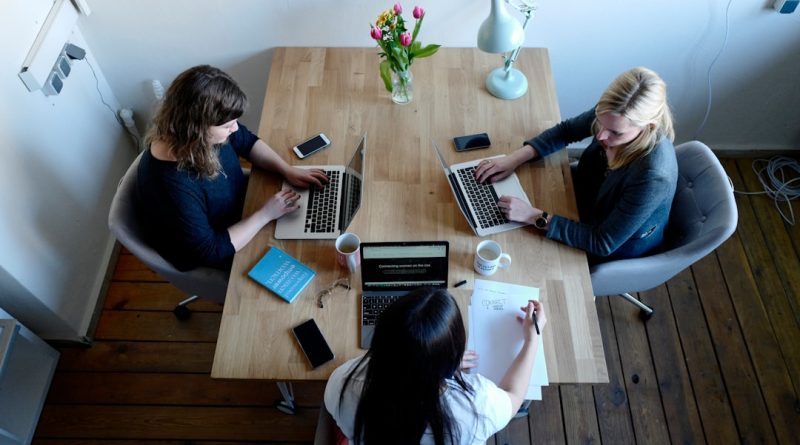 Coworkers reviewing a presentation after a dispute over workplace credit.